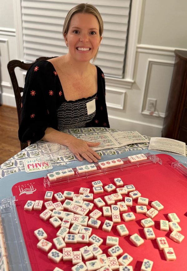 Young woman smiling after winning Mahjong