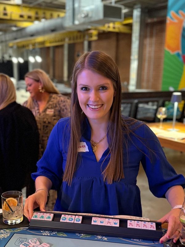 Young woman smiling after winning Mahjong