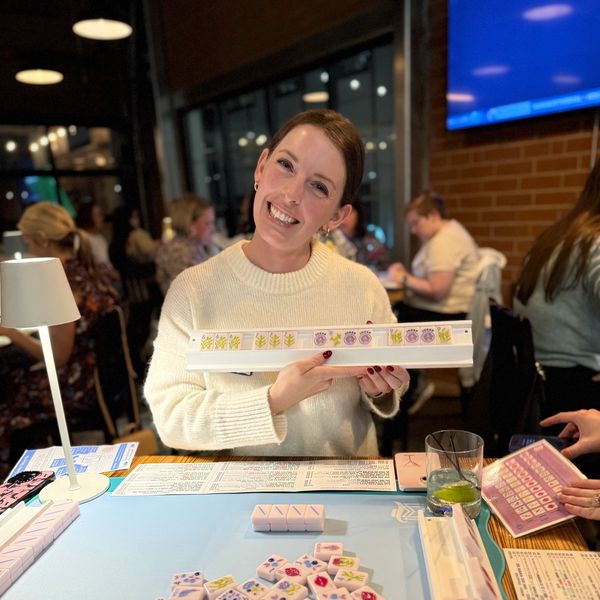 Young woman smiling after winning Mahjong