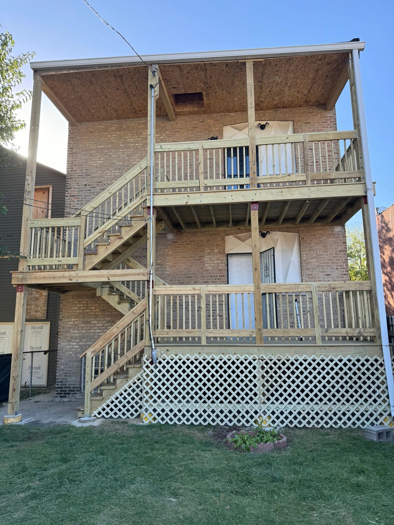 Chicago multi-story porch with new wood decks and stairs after deck violation repair