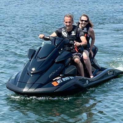 Couple riding a Yamaha WaveRunner jet ski near Monument Beach in Bourne, Cape Cod