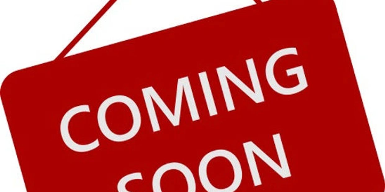 Red sign with white text saying 'COMING SOON'.