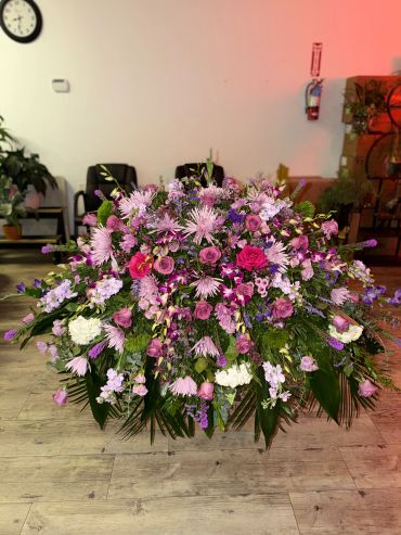 Large floral arrangement with pink and purple flowers.