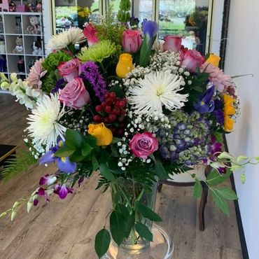 Colorful bouquet of mixed flowers in a glass vase.
