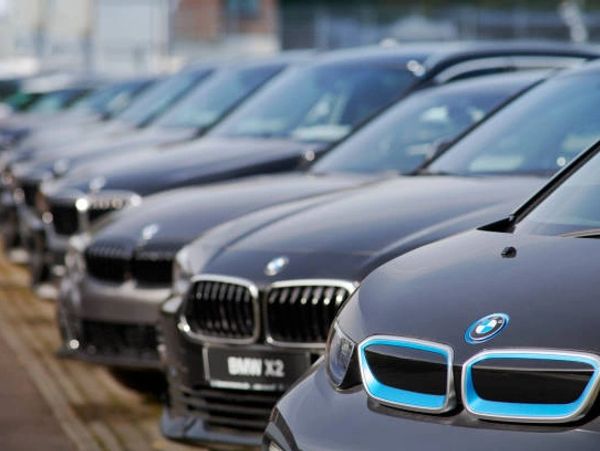 Line of black BMW cars parked in a row outdoors.