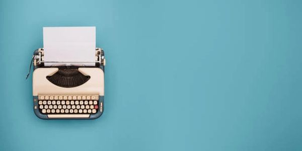 A Typewriter With a White Sheet of Paper