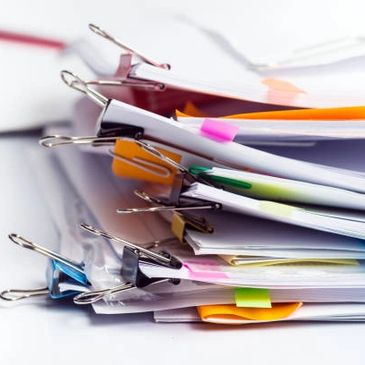 A Bunch of Files With Papers Placed on a Pile