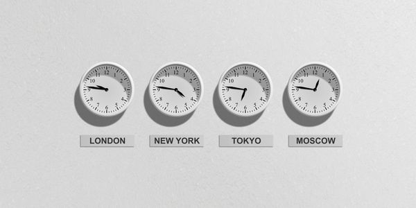 A Bunch of White Color Clocks Placed on the Wall