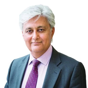 Professional portrait of a mature man in a suit and purple tie.