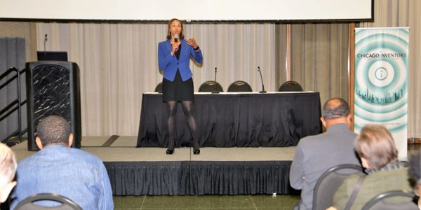 Charis Marquez speaking at Chicago Inventors Organization conference,