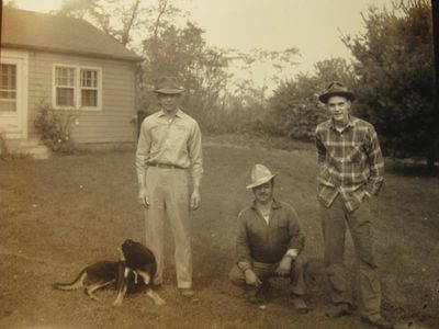 vintage photo of men in hats and dog on a farm