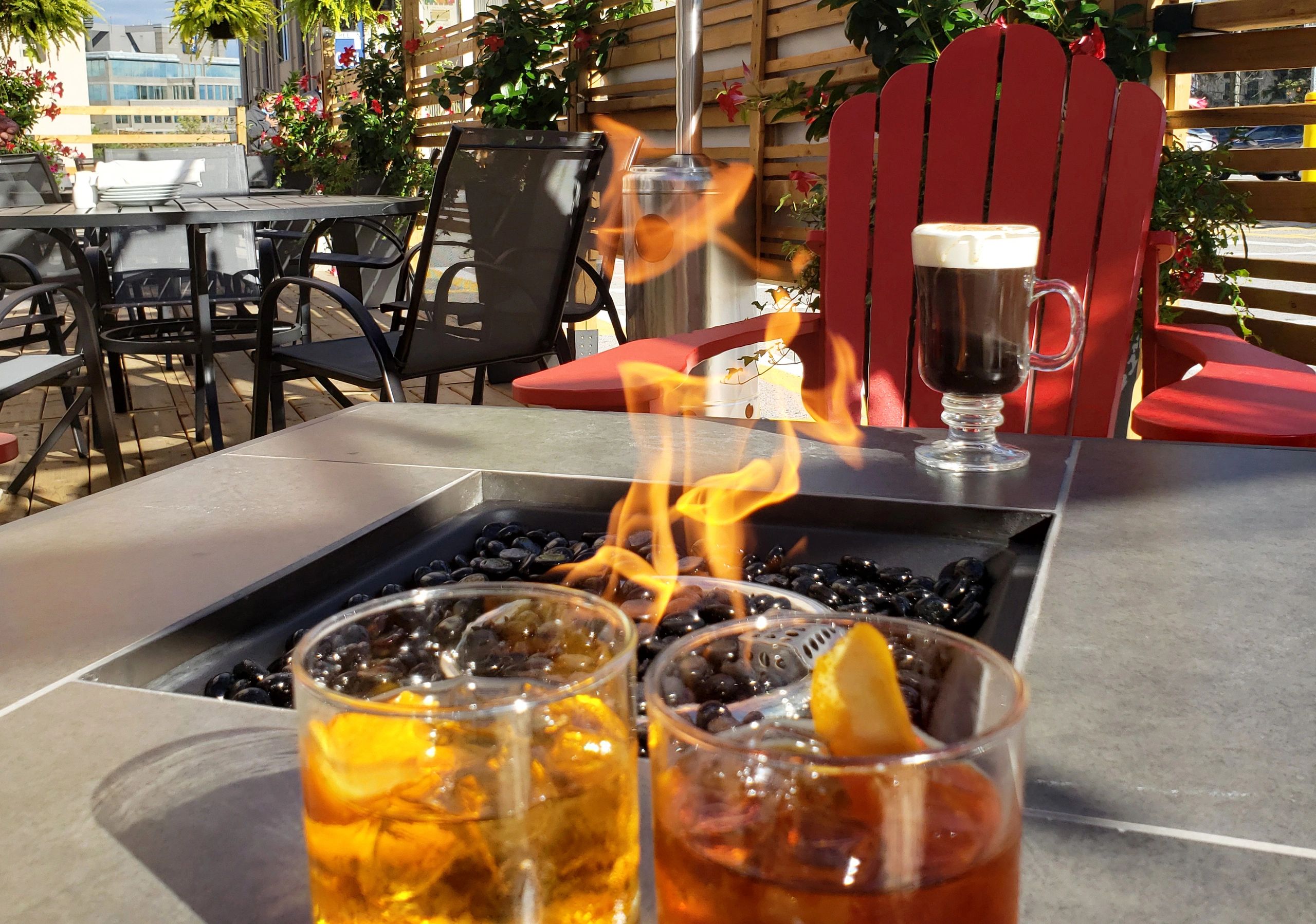 Fall cocktails by private firepit in outdoor Patio Bar & Grill with Muskoka chairs in Richmond Hill