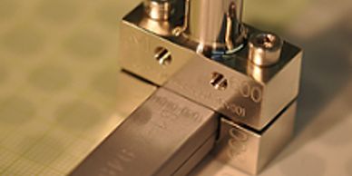 Close-up of a precision metal block with screws.