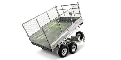 Silver metal trailer with mesh sides tilted upward on white background.