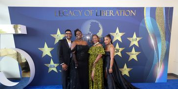 Four people dressed elegantly at a Legacy of Liberation event.