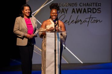 Two women speaking at a Legends Charter Day Awards celebration event.