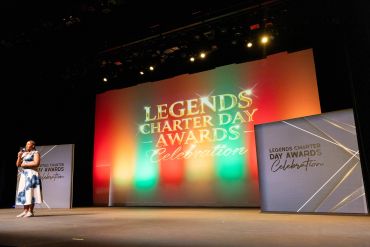A speaker stands on stage at the Legends Charter Day Awards Celebration.