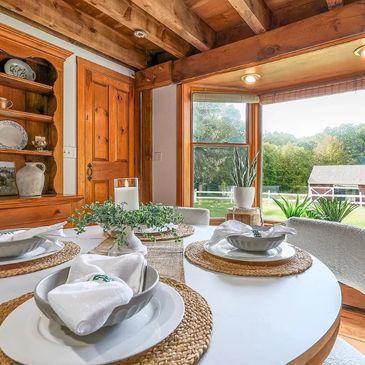 Cozy rustic dining area with wooden accents and garden view.