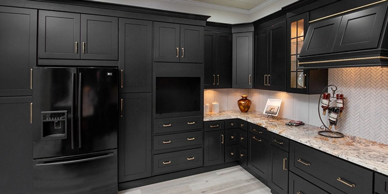 Modern kitchen with matte black cabinets and marble countertops.
