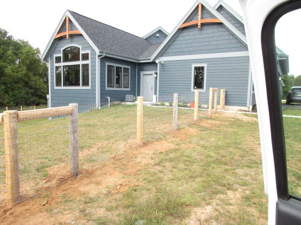 Woven wire dog fence.