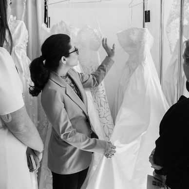 Woman examining wedding dresses.
