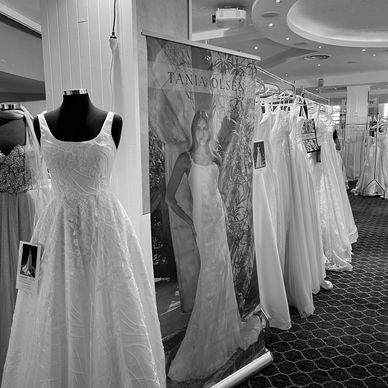Racks of bridal gowns at an exhibitor stand