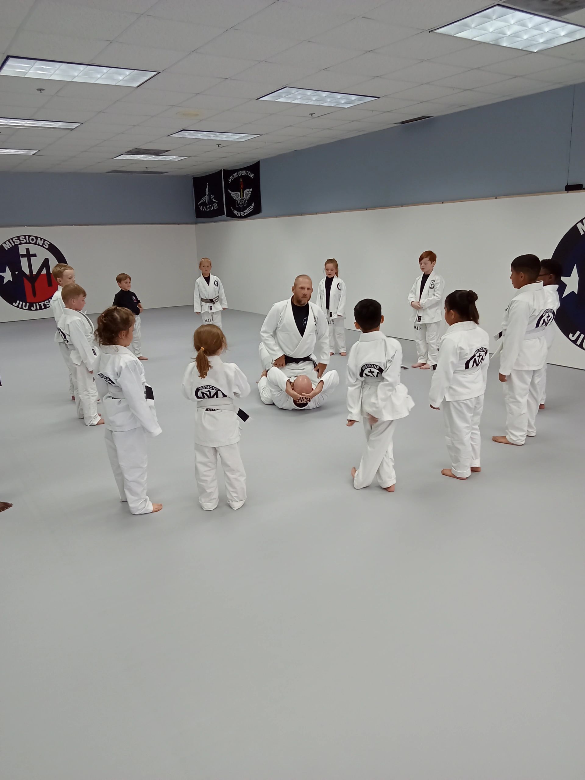 Instructor demonstrating a Jiu-Jitsu technique during kids class