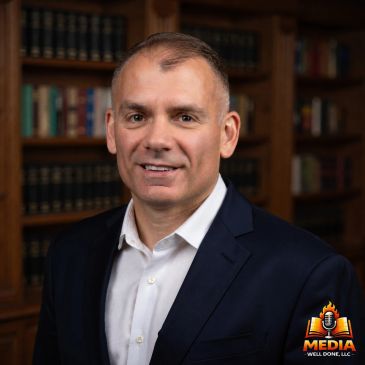 Professional man in suit with bookshelf background.