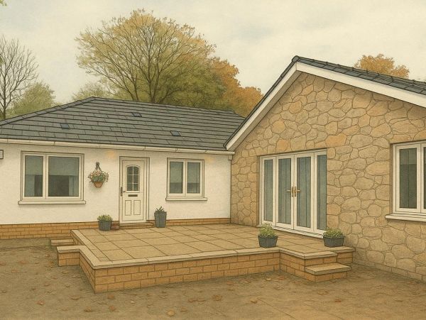 Cozy house exterior with a stone wall and a tiled patio area surrounded by autumn trees.