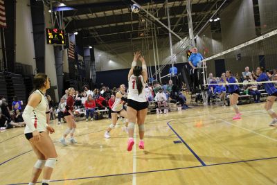 Female volleyball players in action during a game.