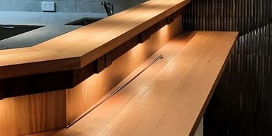 Modern wooden interior with sleek counters and warm lighting.