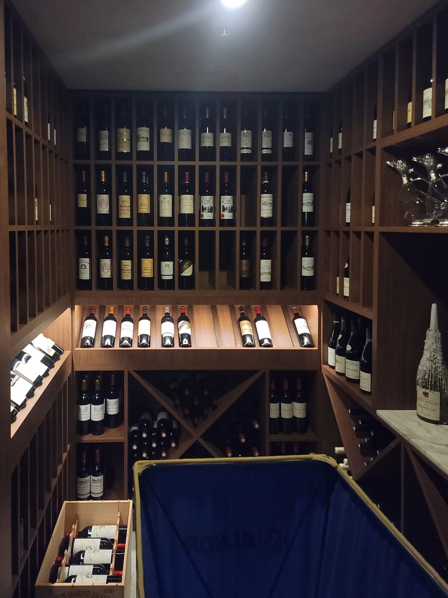 Wine cellar with wooden racks and bottles.