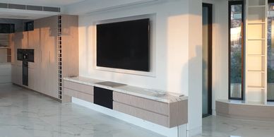 Modern living room with mounted TV and sleek cabinetry.