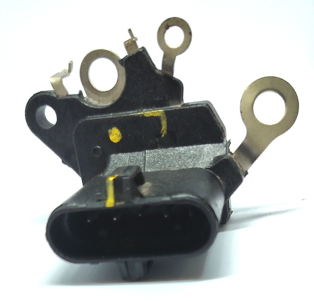 Close-up of a black electrical connector with metal loops and yellow markings.