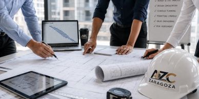 Architects collaborating over blueprints in an office.