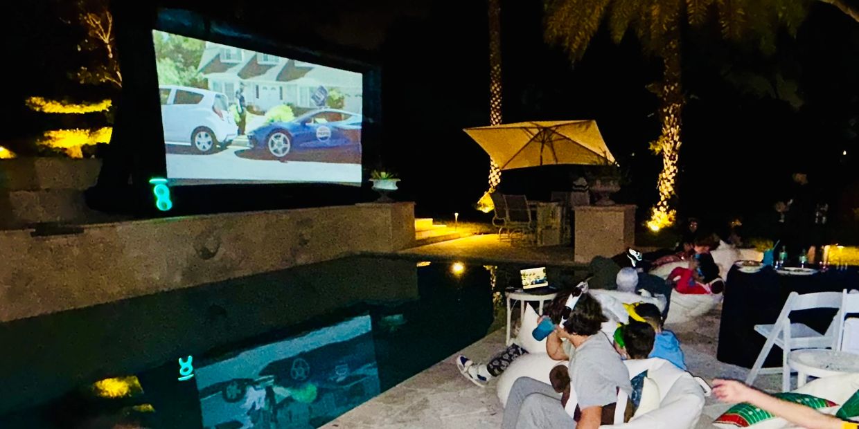 Camp Sweet Dreams Orlando backyard movie night screen rental with projector and chair lounge picnic 