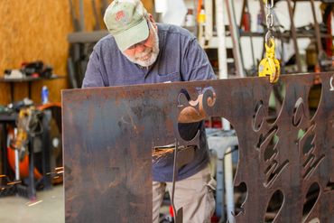 A man preparing a designs using metal