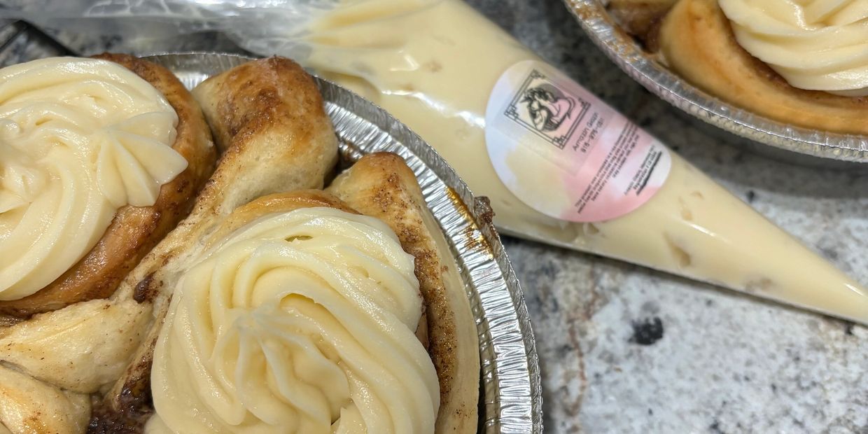 Close-up of cinnamon rolls with cream cheese frosting.