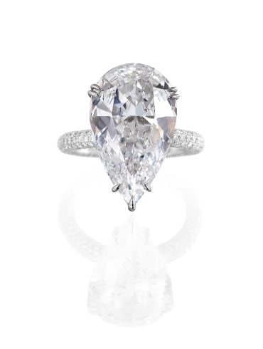 Elegant pear-shaped diamond ring with pavé band.