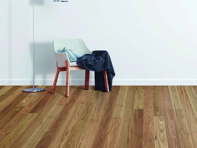 Chair with fabric and pants in a room with wooden floor.