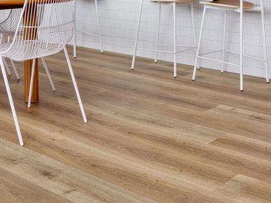 Light brown wood flooring with white wire chairs.