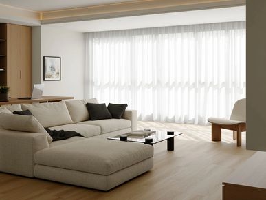 Modern living room with large window and beige sofa.