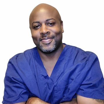 Smiling man in blue medical scrubs against white background.