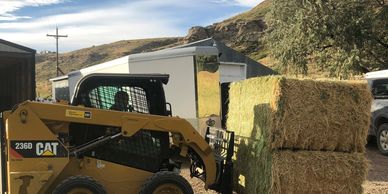 Deliver and stack hay
