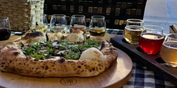 Wood-fired pizza with herb toppings and beer flight.