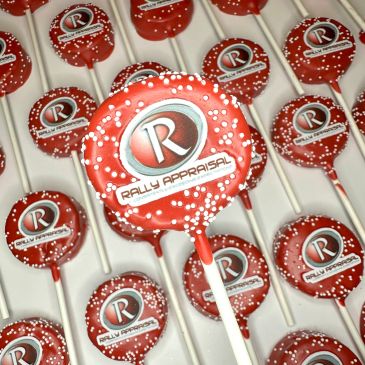 Red and white lollipops branded with Rally Appraisal logo.