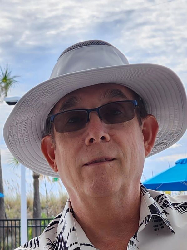 A man wearing sunglasses and a hat.