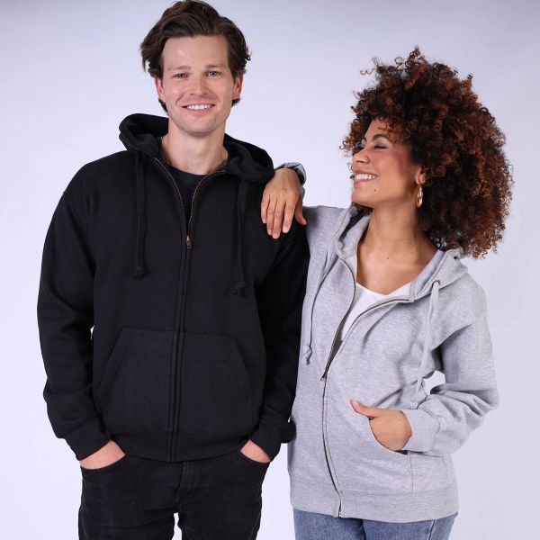A man and pregnant woman wearing hoodies, smiling and posing together.