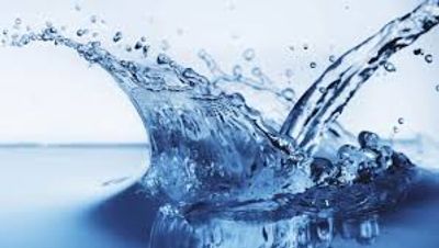 A splash of clear blue water captured mid-motion.