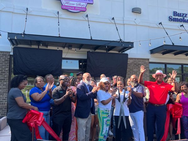 Group celebrates ribbon-cutting at Bloom & Burns Flower Shop and Candle Studio.
